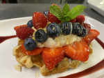 Waffle topped with Greek yoghurt, summer fruits and honey